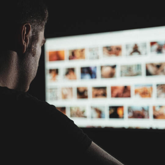 Man browsing porn site late at night.
