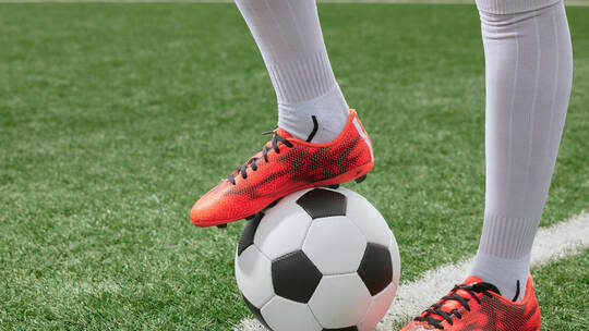 sports girl football player with a soccer ball on the soccer field, the concept of professional women's football