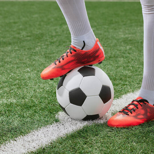 sports girl football player with a soccer ball on the soccer field, the concept of professional women's football