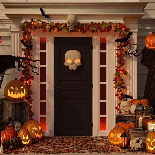 halloween decorated house with pumpkins and skulls. 3d rendering