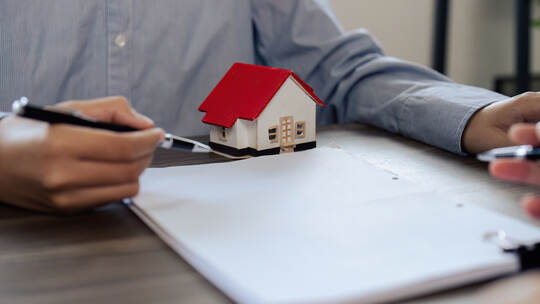 Real Estate Agent explain Property insurance and security concept about house to client before sign contract.