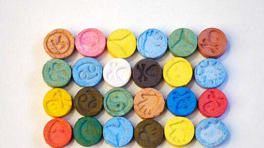 Small color pills of extasy (MDMA, E, X) collected by dealer