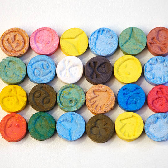 Small color pills of extasy (MDMA, E, X) collected by dealer