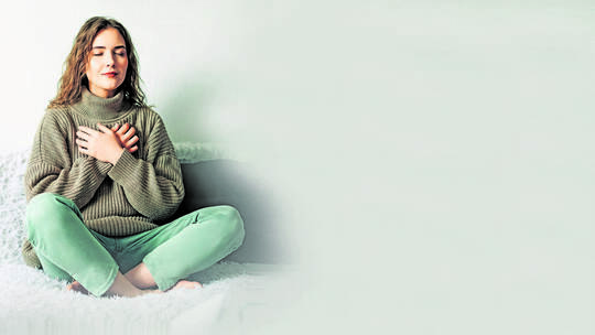 Relaxation techniques: Woman practicing pranayama in lotus position on bed, breathing exercises to reduce stress and anxiety, ac