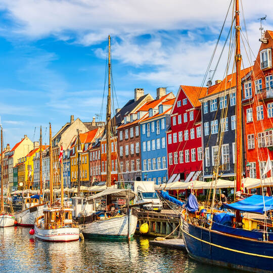 Copenhagen iconic view. Famous old Nyhavn port in the center of Copenhagen, Denmark during summer sunny day