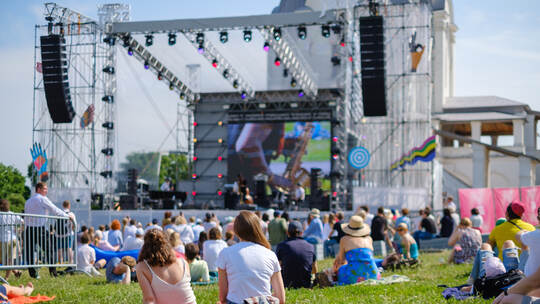 Couple is watching concert at open air music festival
