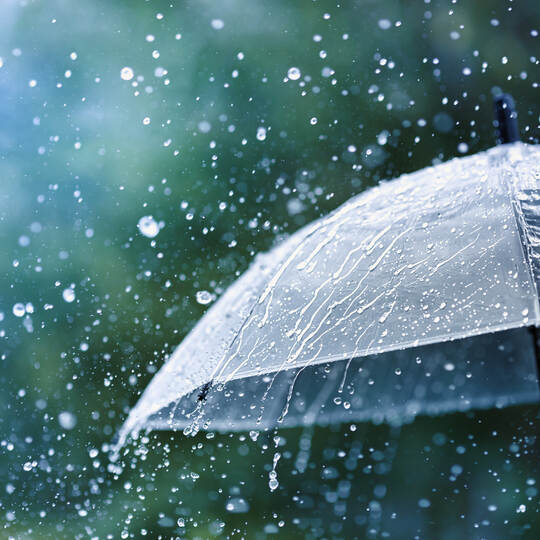 Drops of warm summer rain, falling on the asphalt