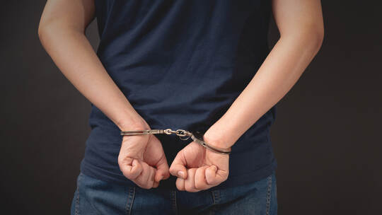 Arrested man with handcuffed hands