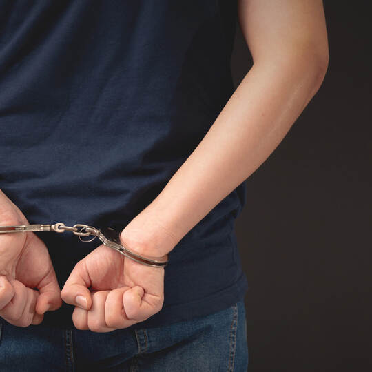 Arrested man with handcuffed hands