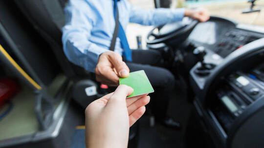 bus driver taking ticket or card from passenger