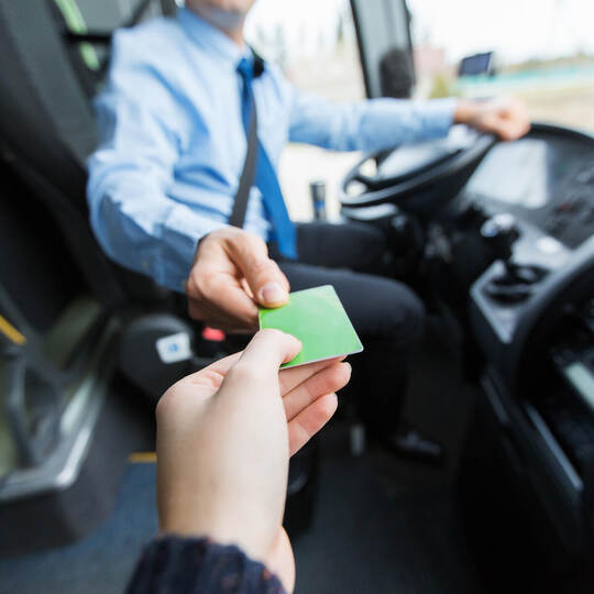 bus driver taking ticket or card from passenger